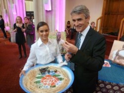 Charles Reed of William Reed Business Media samples the goat stew at Farm Africa's stall