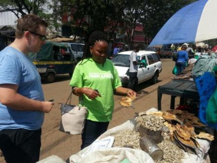 Ashley inspects the fish at Kisumu market with Farm Africa's Susan Otieno