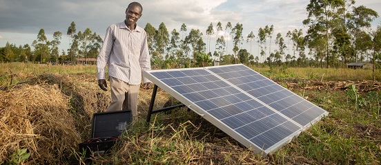 Joseph and a solar-powered pump on his farm