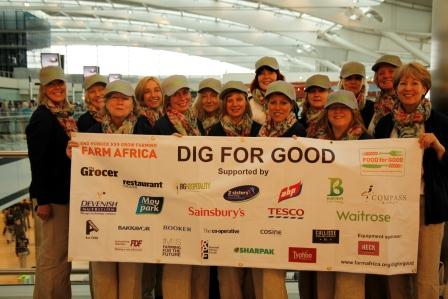 The team of diggers proudly display the banner showing all companies sponsoring Farm Africa's Food for Good campaign