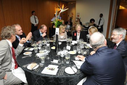 Dinner guests enjoy conversation bewteen courses