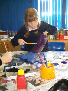 Little girl painting welly