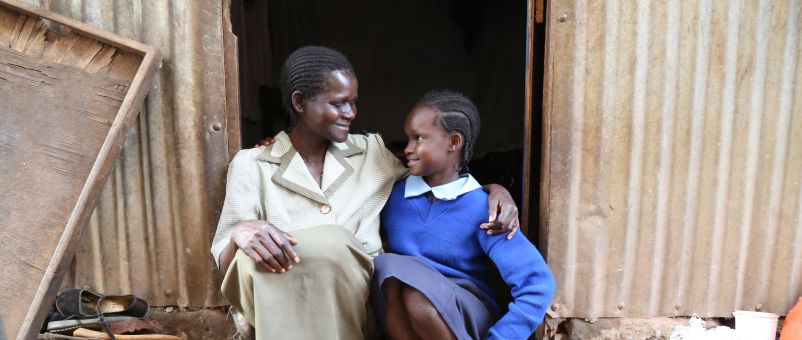Vallary with her mother Hellen outside their home