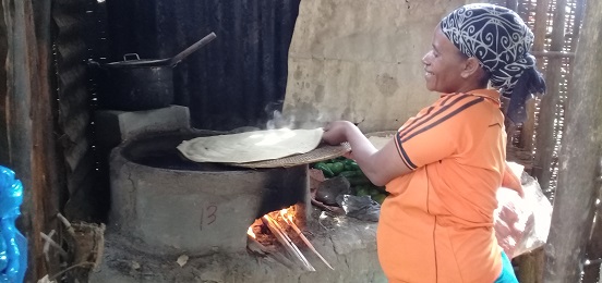 Zemzem cooking with her fuel-efficient stove