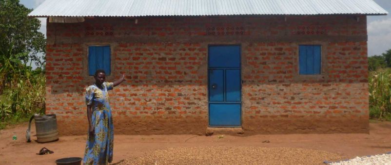 Abiro Joyce outside her new house