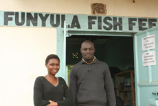 Saul and his wife in front of their aqua shop