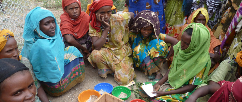 Women in Chacole going through the savings they have collected as a group.